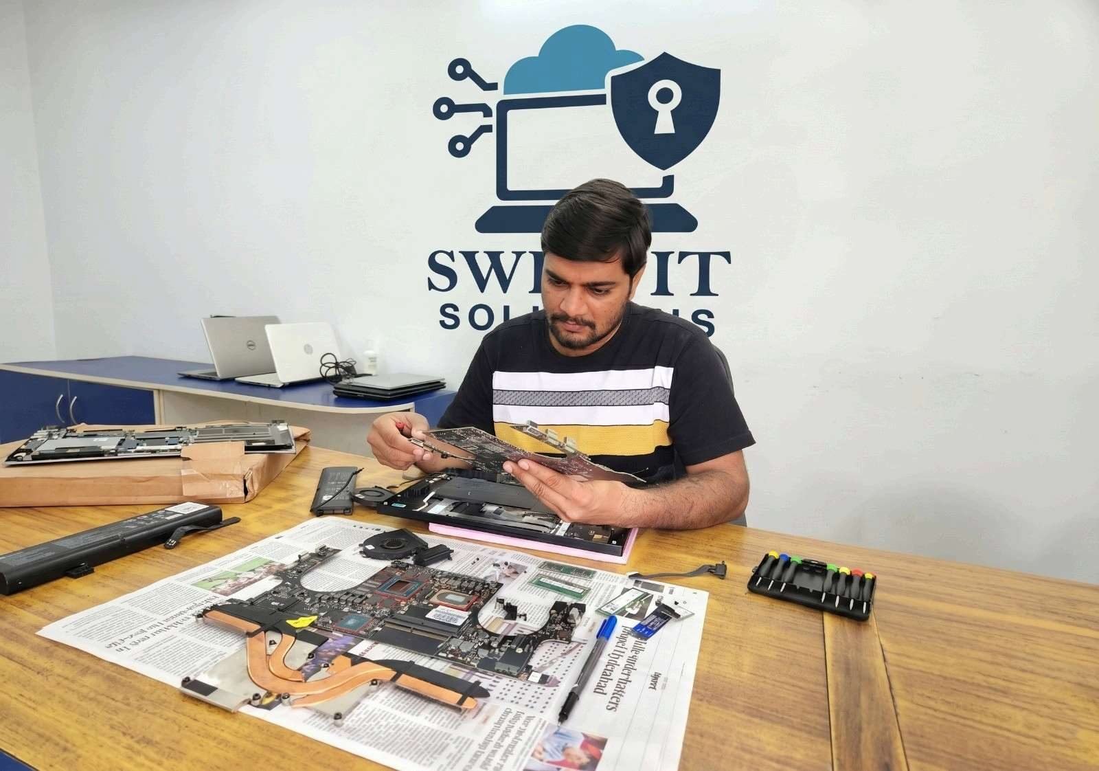 SwiftIT Solutions technician servicing office IT equipment